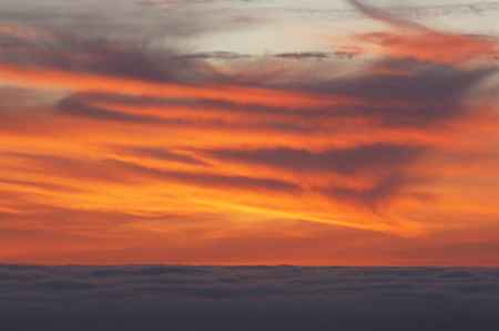 Clouds Glowing Orange-Red Over Indigo Fog